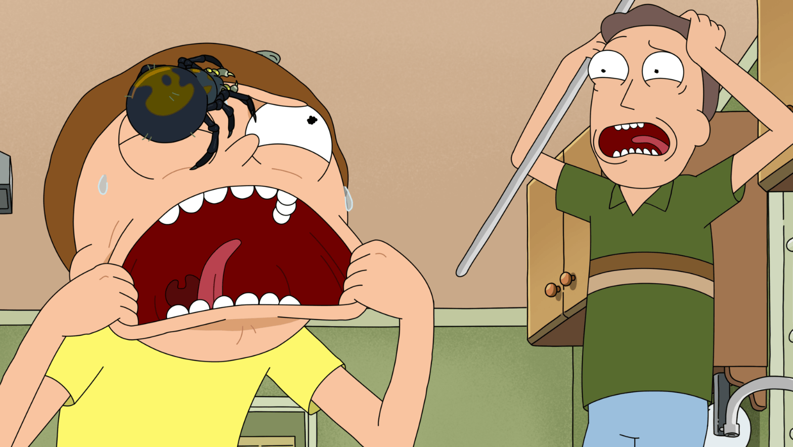 A cartoon character screams in terror, a spider on their forehead. Another character, also frantic, holds a stick, wide-eyed. Both show panic in a kitchen setting.